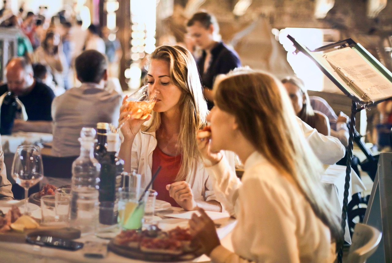 Folks enjoying restaurant food. Photo by Andrea Piacuadio